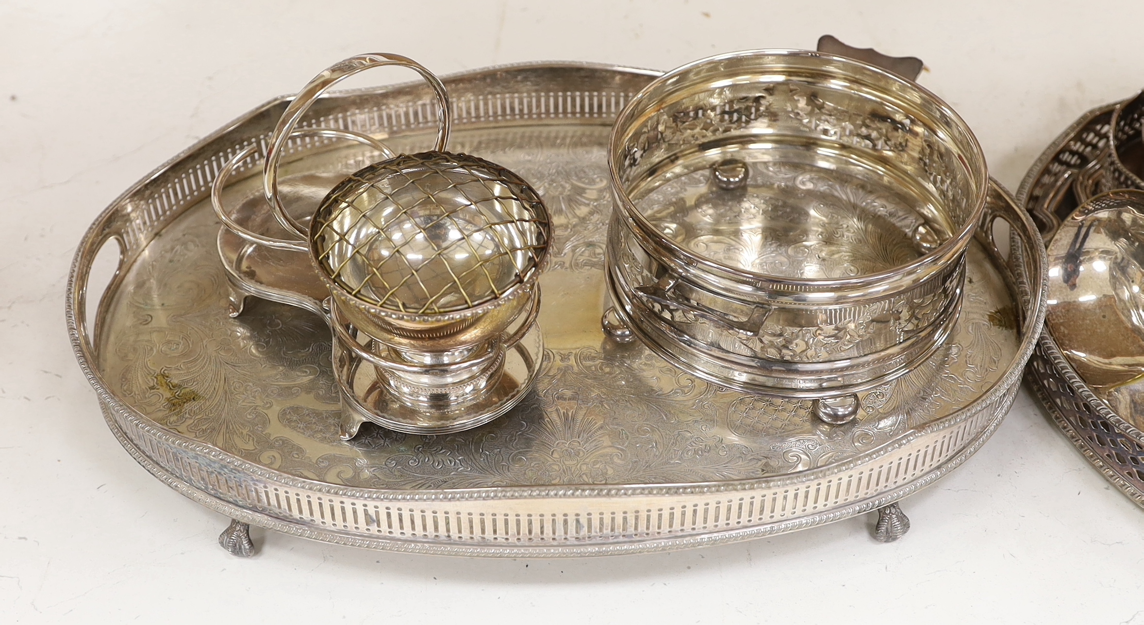 A quantity of silver plate including two trays with pierced galleries, a wine coaster, condiment serving pots, etc.
